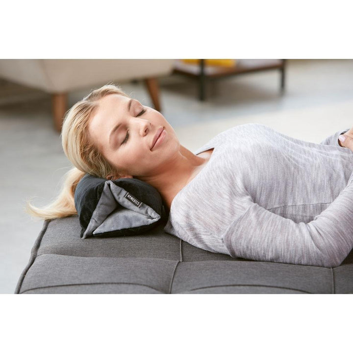 Woman lays on floor and enjoys a massage from the Homedics Thera-P Versatile Vibration Massage Pillow