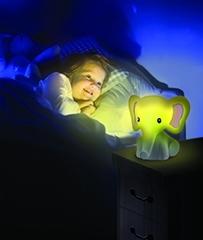 Illustration of child smiling in bed next to Homedics MyBaby Comfort Creatures Elephant on nightstand