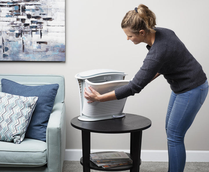 Woman closes side of Homedics TotalClean after adding Replacement Carbon Pre-Filter