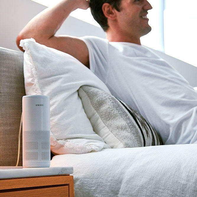 White | Man relaxes on couch with the Homedics TotalClean 4-IN-1 UV Portable Air Purifier in white on end table