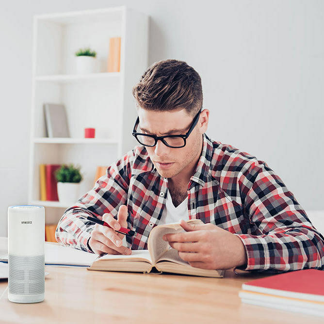White | Man reads book at desk next to the Homedics TotalClean 4-IN-1 UV Portable Air Purifier in white