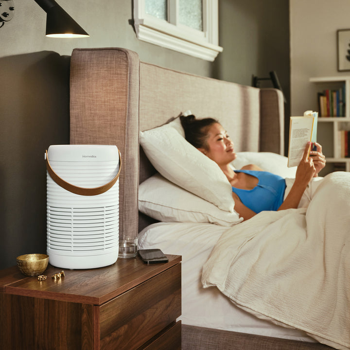 Air Purifier T95 cleans the air of her bedroom while she relaxes with a good book
