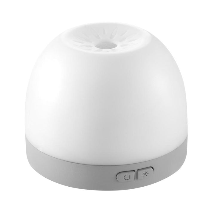 Homedics Personal Portable Aroma Pad Diffuser next to luggage
