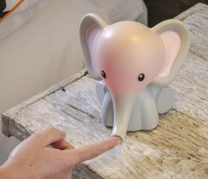 Hand places finger in trunk of the Homedics MyBaby Comfort Creatures Elephant