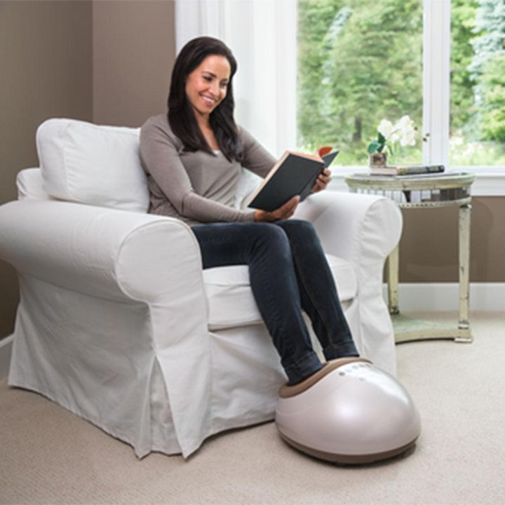 Grey | Woman sits in chair and enjoys a heated foot massage from the Homedics Shiatsu Air Pro Foot Massager with Heat