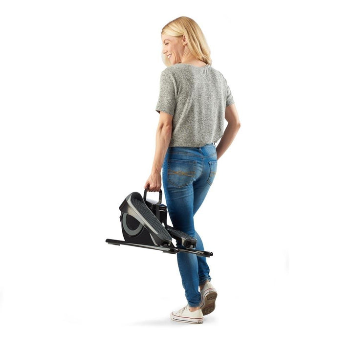 Woman carrying the Homedics Stayfit Mini-Stepper