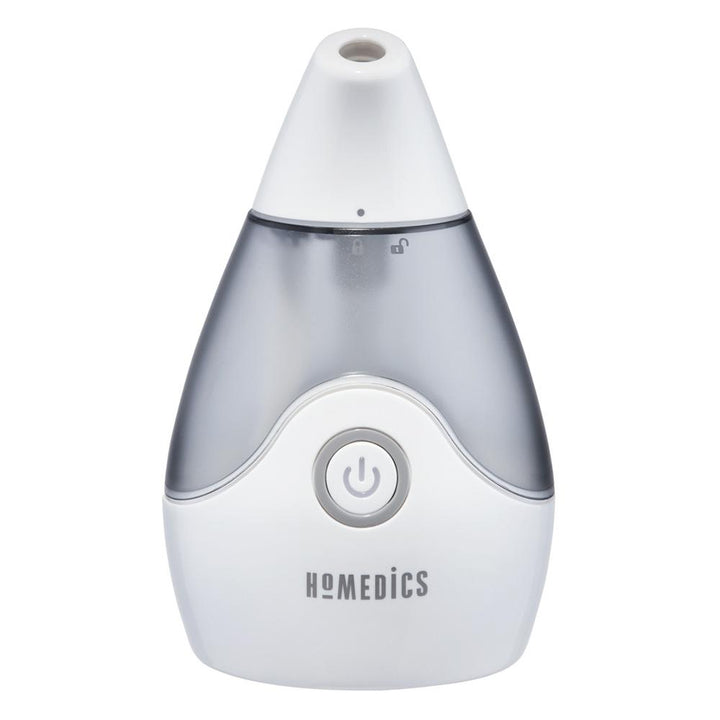 Woman smiles while looking at Homedics TotalComfort Personal Ultrasonic Humidifier on table