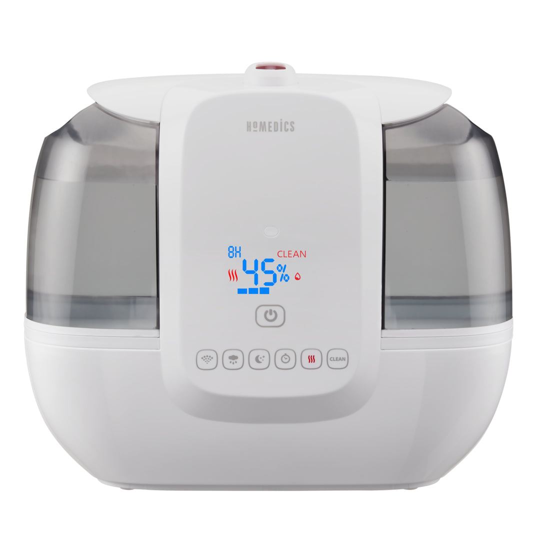 A woman pours water from the top of the TotalComfort® Ultrasonic Humidifier with UV-C Technology and Remote Control