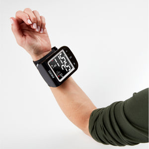 Model arm wearing Homedics Premium Wrist Blood Pressure Monitor with Attached Wrist Cuff