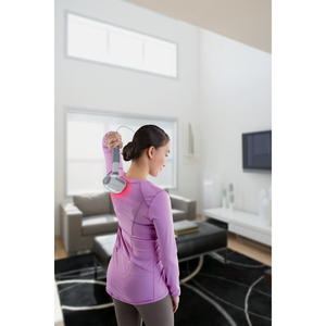 Woman in purple shirt uses Homedics® Hot & Cold Vibration Body Massager on back