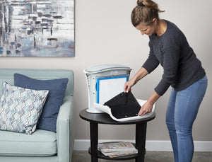 Woman adds new Homedics TotalClean Replacement Carbon Pre-Filter to TotalClean on table