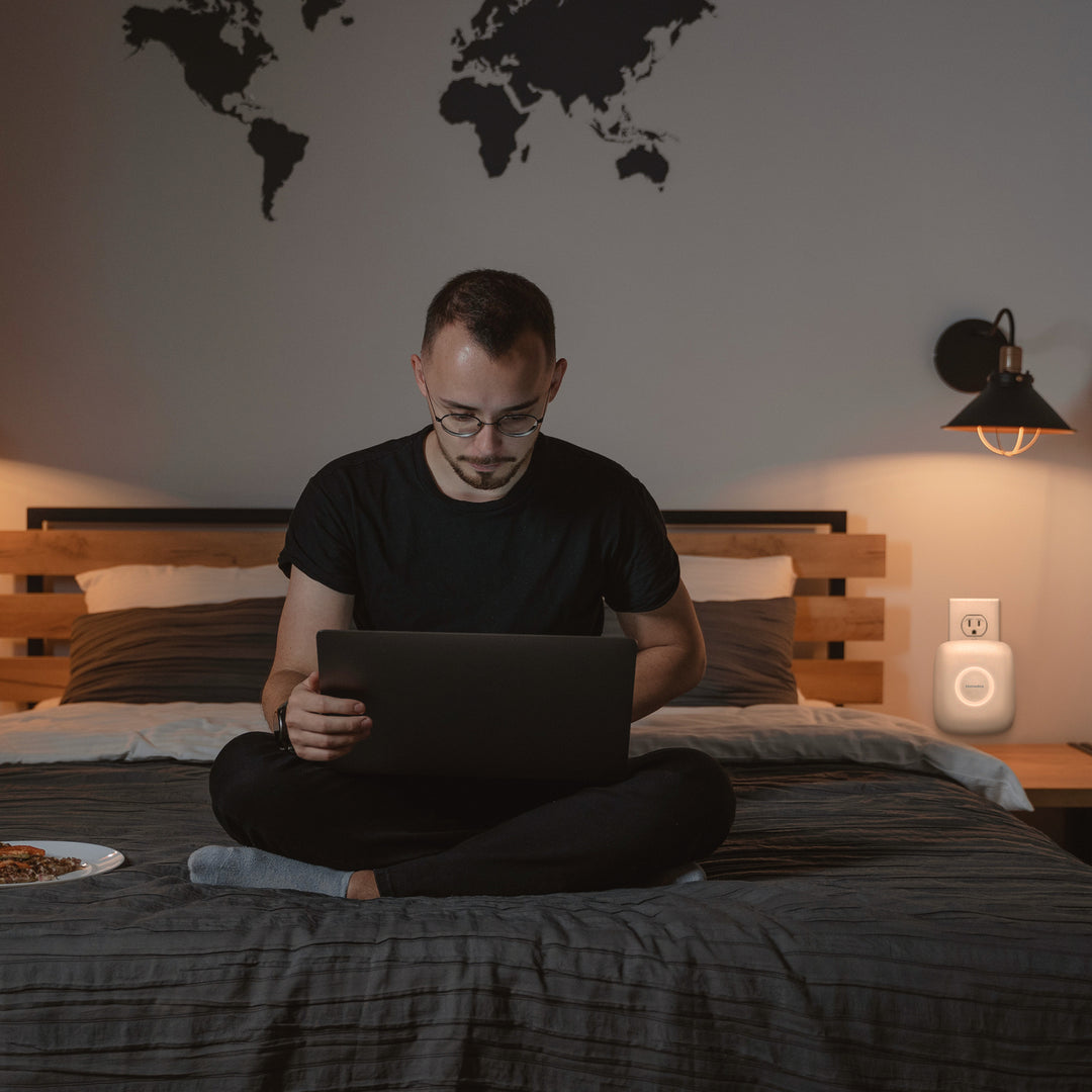 Plug-in Air Purifier P23 - 2 pack purifies the bedroom air while he types away on his laptop