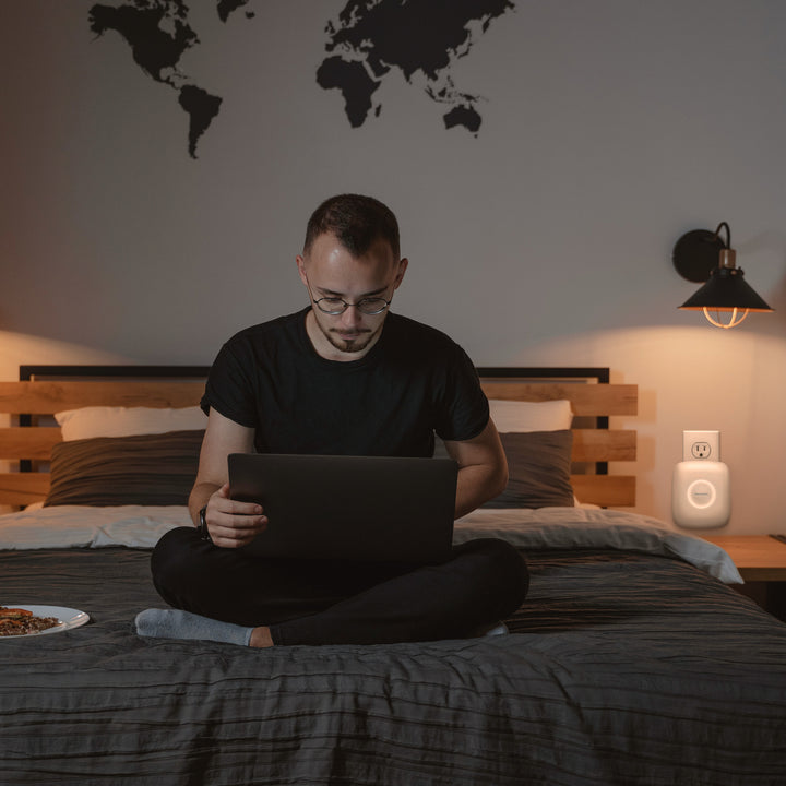 Plug-in Air Purifier P23 - 2 pack purifies the bedroom air while he types away on his laptop