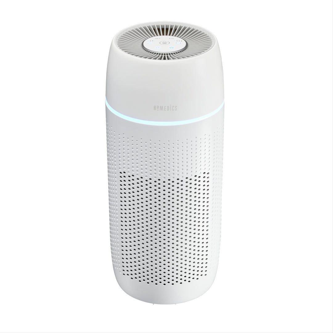 Woman sitting with the Homedics TotalClean PetPlus 5-in-1 Air Purifier that removes 99.97% airborne allergens.