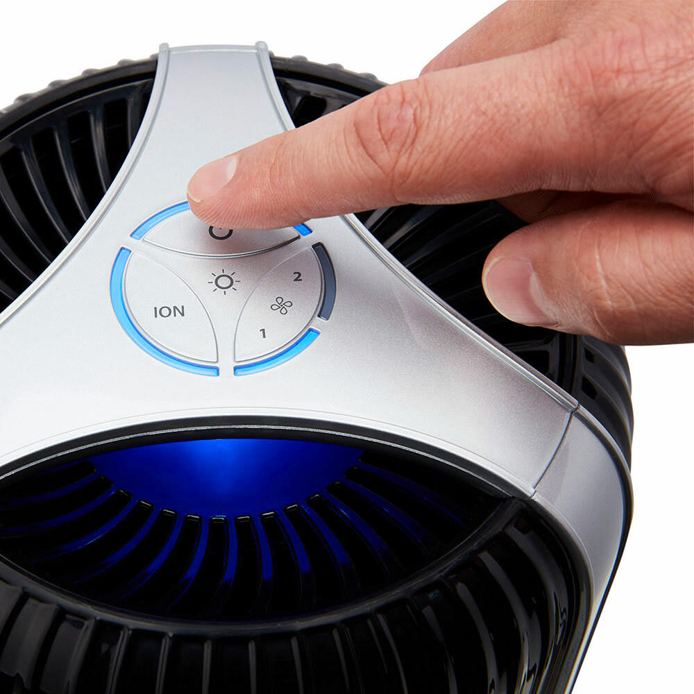 Black | Hand presses power button on the black Homedics TotalClean 4-in-1 Small Room Air Purifier