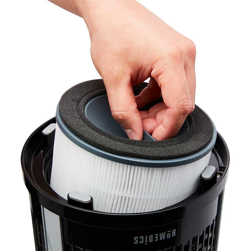 Black | Hand replaces filter on the black Homedics TotalClean 4-in-1 Small Room Air Purifier