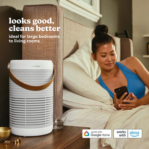 Smart Air Purifier T100 purifies the air while a woman lays in bed and uses her smart phone to access the controls
