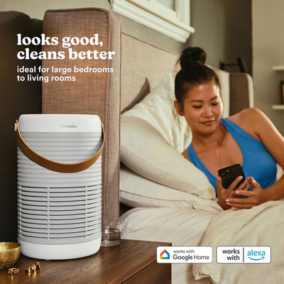Smart Air Purifier T100 purifies the air while a woman lays in bed and uses her smart phone to access the controls