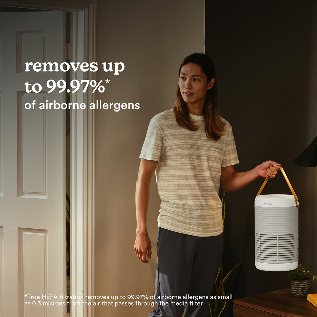 Man carrying Smart Air Purifier T100 with using its strong handel