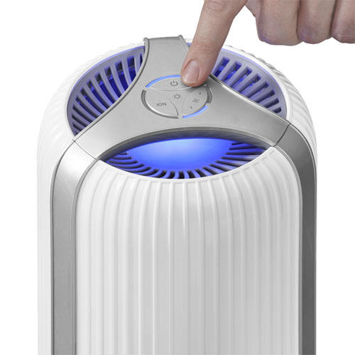 White | Hand presses power button on the white Homedics TotalClean 4-in-1 Small Room Air Purifier