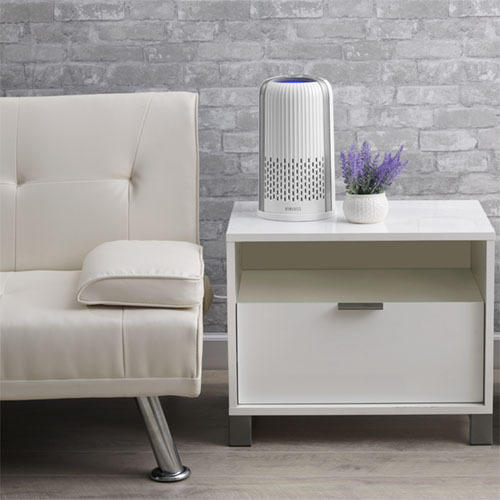 White | White Homedics TotalClean 4-in-1 Small Room Air Purifier sitting on table next to couch