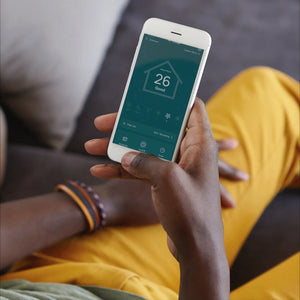 Couple laying on bed with pet next to the Smart Air Purifier T200 placed on the side table. Removes 99.97% of airborne allregens