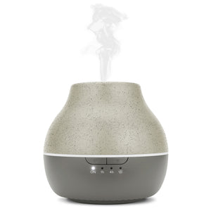 Steam is coming out of Homedics® diffuser and a woman inhales the same for calm experience.