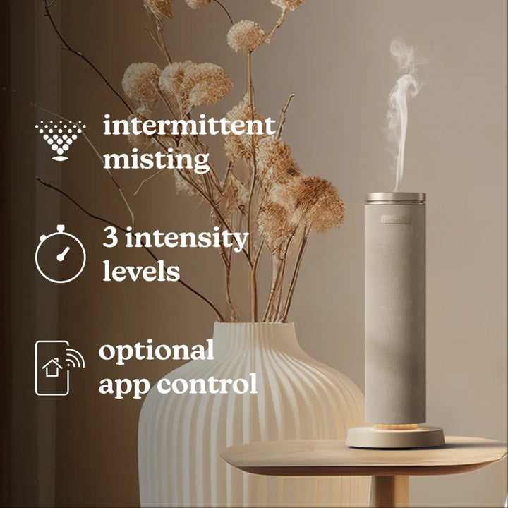 SereneScent™ Fabric Waterless Diffuser placed on table with featured displayed like intermittent misting, 3 intensity levels and optional app control