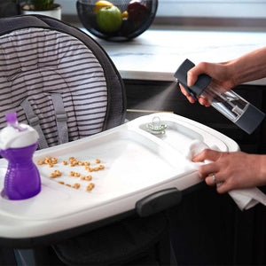 Hands spray child table with Homedics Ozone Clean Multipurpose Cleaner