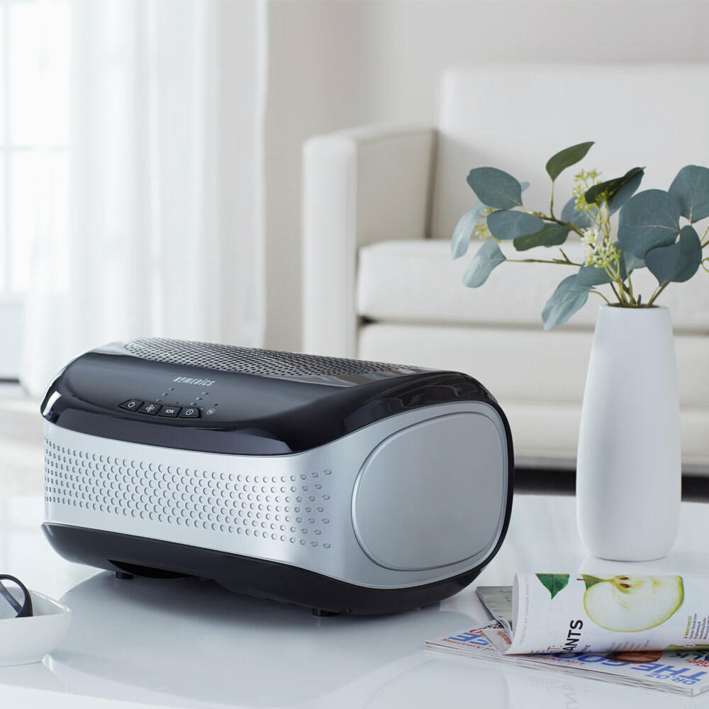 Black | Black Homedics TotalClean Desktop Air Purifier on table next to plant