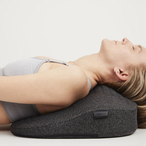 Woman relaxes on the Homedics Body Flex Mini Stretch Mat with Heat