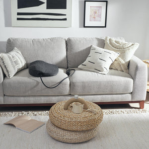 Homedics Body Flex Mini Stretch Mat with Heat sits on gray couch