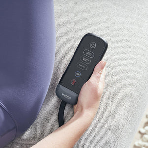 Close-up of hands holding the programmable controller for the Homedics Body Flex Mini Stretch Mat with Heat