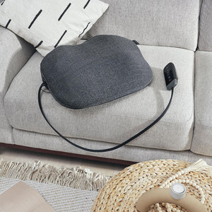 Zoomed in view of the Homedics Body Flex Mini Stretch Mat with Heat sitting on gray couch