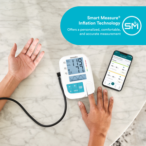 Someone measuring blood pressure on left arm and checking pulse with right index finger while using the Homedics® Relax+ Upper Arm 900 Series Blood Pressure Monitor for Easy, Accurate Results