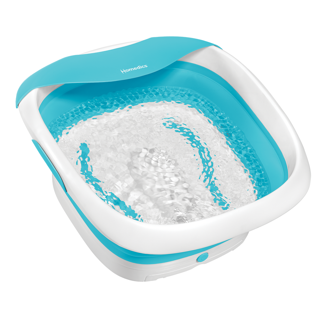 Feet inside the Homedics Compact Pro Spa Collapsible Footbath with Heat and adding salt