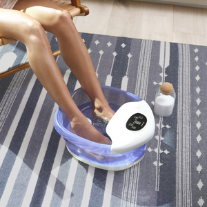 Woman relaxes in chair with feet soaking in the Salt-N-Soak Footbath with Heat Boost