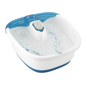 Woman sits on the end of the bathtub with feet in the Homedics Bubble Mate Foot Spa with Heat