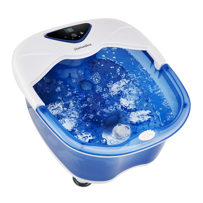 Woman is done soaking her feet and is carrying the Salt-N-Soak Pro Footbath with Heat Boost by the handle