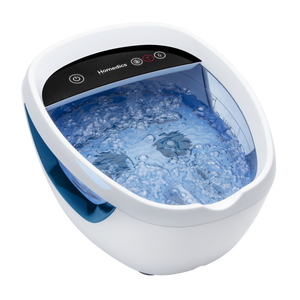 Woman playing with child as she also relaxes by putting her feet into the Shiatsu Bliss Foot Spa with Heat Boost