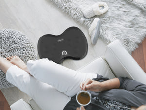 Shiatsu Foot Massager with Heat FMS-152H-CA view from above, massager on the floor in living room setting with person drinking coffee