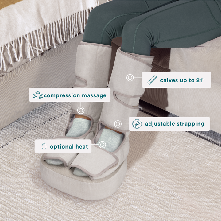 Woman in green leggings sits in chair while wearing the Homedics Real Relief Leg & Foot Massager