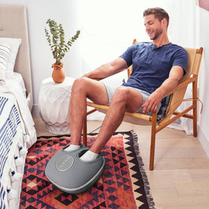 Lifestyle image of Man using Shiatsu-Air Deluxe Massager with Heat while sitting in a chair