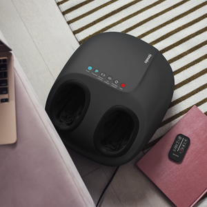 Top view of the 3-in-1 Pro Foot Massager with Heat with remote next to it on top of a book