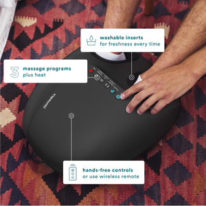 Man on couch using the 3-in-1 Pro Foot Massager with Heat changing the settings