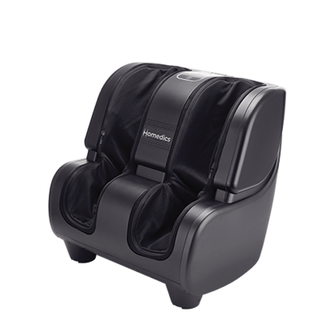 Man getting his feet warm and relax while working on laptop with the Homedics Therapist Select Foot and Calf Massage