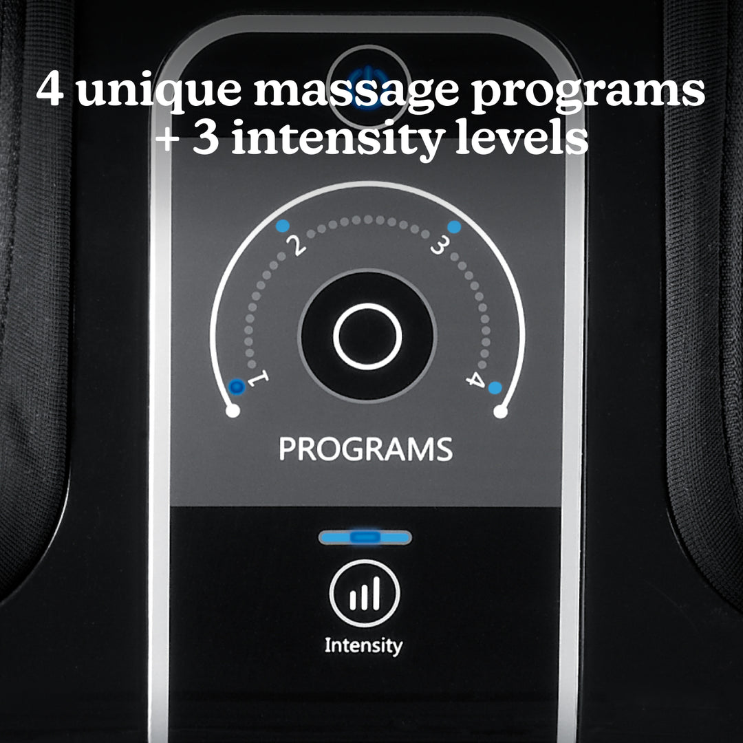 Woman sitting on couch with family while enjoying a massage from the Homedics Therapist Select Foot and Calf Massager