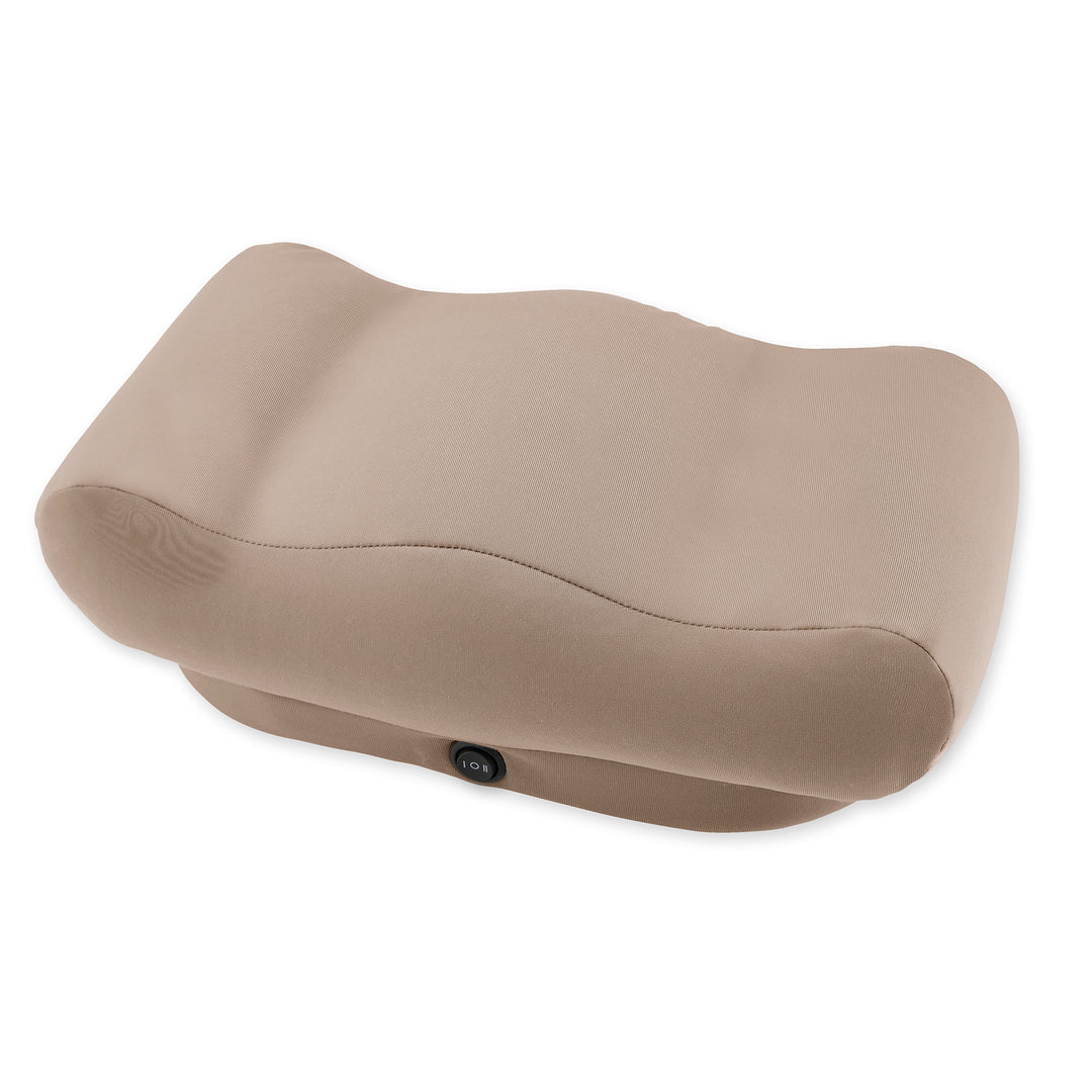 Woman enjoying her morning coffee sitting at a table while massaging her feet with the Homedics Comfy Footrest Massager