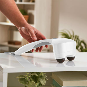 Homedics® Duo Percussion Body Massager with Heat is picked up from the counter and ready to provide releif
