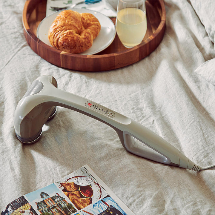 Brown | Homedics Percussion Action Plus Handheld Massager with Heat on bed